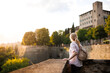 © encierro - Woman tourist enjoying sunset view from city Venetian walls of Bergamo, Italy during solo travel vacation in Europe