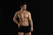 © New Africa - Young man in stylish underwear on black background