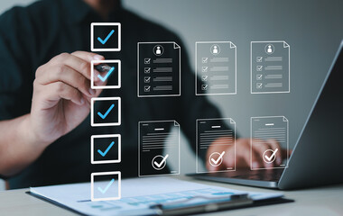 male businessman doing online survey and digital form checklist with laptop computer, document manag