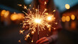 © Nelly - Young woman holding a sparkler in a festive evening setting