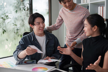 Wall Mural - creative workshop and team dynamics. a diverse team discussing design ideas with color swatches in a