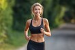 © Iryna - A woman is running on a road with a smile on her face. She is wearing a black tank top and black leggings