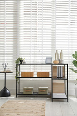 Poster - Console table with different decor near window indoors. Interior design