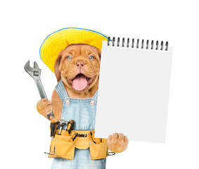 Poster - Funny Mastiff puppy wearing summer hat and denim overalls with tool belt shows empty list and wrench. Isolated on white background