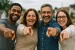 © Rawpixel.com - Diverse group happily pointing.