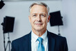 © Evgenii Starkov - Confident Businessman in Studio Setting
