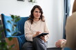 © Andrii Zastrozhnov - Young caucasian female therapist taking notes during counseling session