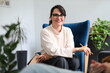 © Andrii Zastrozhnov - Young caucasian female therapist with glasses in office setting