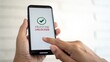 © Komdo - A hand holding a smartphone displaying a screen that says 'Milestone Unlocked' with a checkmark.