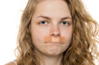 © vladimirfloyd - Young woman with curly blonde hair and bandages on upper lip from hair removal injury, close-up on white