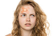 © vladimirfloyd - Thoughtful portrait of young woman with bandage on forehead, curly blonde hair. Close-up, white background.