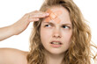 © vladimirfloyd - Thoughtful portrait of young woman with bandage on forehead, curly blonde hair. Close-up, white background.