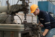 © amorn - Industry factory, machine. Engineer worker, maintain, repair mechanism of operation of drilling milling machine in workshop