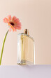 © ADDICTIVE STOCK - Minimalist style perfume bottle and pink flower