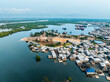© AmazingAerialAgency - Aerial view of scenic waterfront with residential buildings, boats, and lush greenery, Baptist, Rivers, Nigeria.