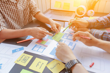 Wall Mural - web designers are working together to develop mobile responsive website with ui ux front end designe
