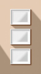 Canvas Print - three white picture frames mockup hanging vertically on a beige wall with light and shadow casting f
