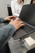 © Alejandro - A focused boss writes on a tablet during work, highlighting modern technology, productivity, and professional organization in a business environment.
