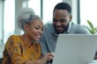 © Proshanto49 - Happy couple using a laptop together at home