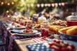 © antusher - Long outdoor table filled with food and drinks in backyard picnic setting under sunlight