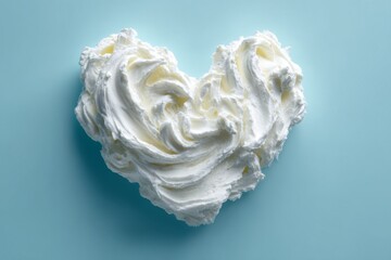 Shea butter cream in a heart shape with a textured smudge stroke appearance on a beige brown background