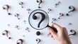 © Muhammad - Finding solutions, woman's hand holding magnifying glass over question marks