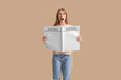 © Pixel-Shot - Emotional young woman with blank newspaper near color wall