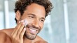 © Newleks - Hispanic man moisturizing face, smiling softly while looking aside during morning skincare routine, radiating self care and personal wellness in bathroom setting