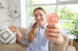 © Pixel-Shot - Young woman with mini fan at home, closeup