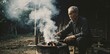 © Firman Dasmir - Vintage portrait of an elderly charcoal maker overseeing the smoldering fire