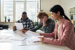 © Mediaphotos - Students from diverse backgrounds engaging in studying and discussing foreign languages in classroom filled with natural light and educational materials present