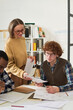 © Mediaphotos - Group of diverse students engaging in studying foreign languages in classroom. Examining notes and diagrams, participants collaborating, sharing ideas, improving language skills