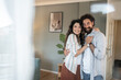 © Migma_Agency - Happy couple embracing in their new home, celebrating new beginnings