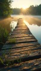 Poster - Wooden Boardwalk Leading to Misty Lake at Sunrise with Golden Sunlight and Green Plants in a Rural Setting