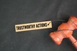 © Fauzi - Judge's gavel and paper tag with the words trustworthy actions