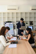 © saltdium - Diverse Business Team Collaborating During Office Presentation, Vertical image