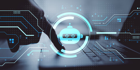 Fototapete - Futuristic chatbot interface with robotic icon overlaying person using laptop for artificial intelligence technology concept on digital background.