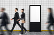 © Who is Danny - Blank vertical digital advertising display with people walking by in motion blur in tiled subway station corridor background.