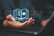 © Nirusmee - Internet education concept, e-learning resources, e-book, distant online courses, e-library. Businessman using laptop e-book icons on virtual screen.