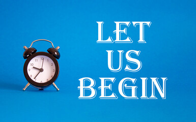 Wall Mural - let us begin symbol. concept word let us begin on beautiful blue background with alarm clock. busine