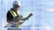© Grispb - Man foreman of construction team. Builder with papers in hands. Foreman in service uniform. Man architect stands near blurred construction landscape. Foreman reads construction drawings