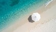 © SA7 - Breathtaking aerial view of a pristine tropical beach with crystal-clear turquoise water and a white umbrella providing shade. Perfect for travel and vacation themes!