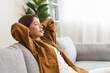© Pormezz - Young woman enjoying mind free moment relax and calm on the sofa at home.