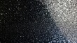 © Nuttaya Nampai - Elegant black to silver glitter texture gradient with fine sparkling dust, creating a sophisticated abstract background.