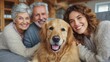 © Pravinrus - Family petting their golden retriever while sitting together on a sofa in their living room at home