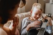 © looking2thesky - Mother and son playing guitar together, family love. The child wears a hearing aid, highlighting inclusivity and the universal language of music. Authentic, unedited photo captures emotions