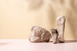 © Kamitana - A refined stone podium set against a beige backdrop, enhanced with soft natural shadows—perfect for showcasing beauty products or luxury items with an elegant and earthy tone.