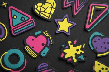 Poster - Retro 80s Style Neon Stickers Displayed on a Dark Surface Creating a Vibrant and Playful Aesthetic