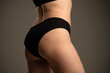 © kinomaster - Detailed View of a Womans Hip and Buttocks on Neutral Background