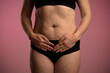 © kinomaster - Woman Holding Stomach: Experience of Abdominal Discomfort